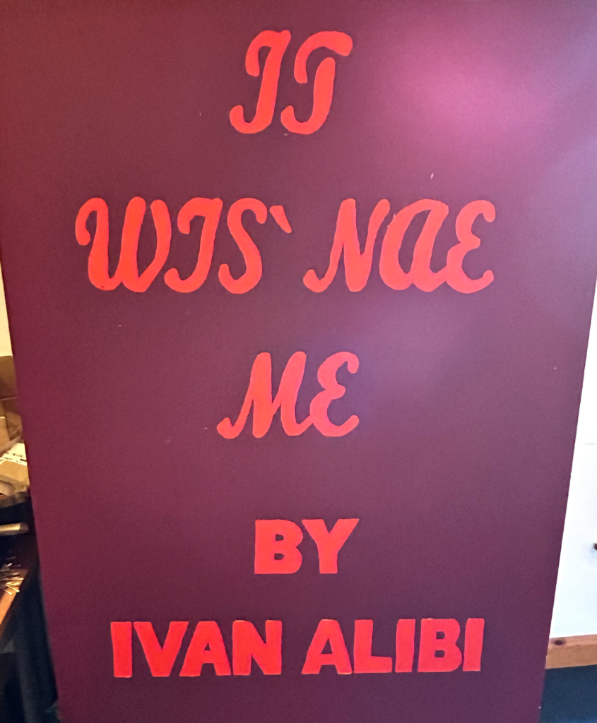 Purple banner reading "It wis' nae me by Ivan Alibi' - seen at Perth Campus, UHI